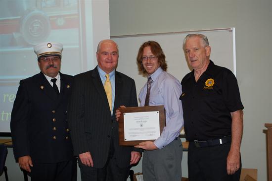The Ronald Fitzpatricks Firefighter 1 Award was presented to Aaron H. Carley, Class 98 of the Long Branch Fire Department, in recognition of his high test scores. Pictured from left to right: Fire Marshal Henry Styker III, Freeholder John P. Curley, Aaron H. Carley and Fire Academy instructor Frank Bostjancic.